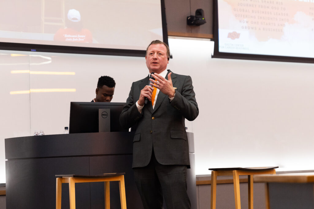 Joe Eastin speaking to an audience in a lecture hall