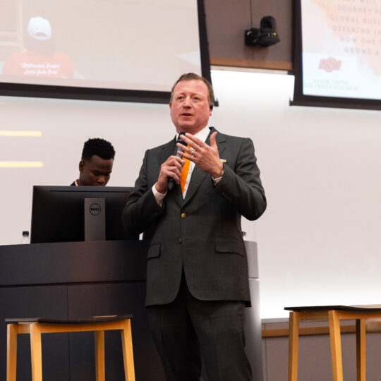 Joe Eastin speaking to an audience in a lecture hall